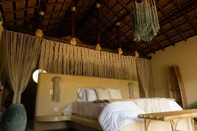 a bedroom with a bed with a mosquito net above it at Holistic EcoHotel in Santa Fe de Antioquia