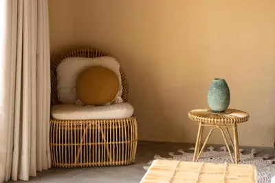a room with a chair and a vase on a stool at Holistic EcoHotel in Santa Fe de Antioquia
