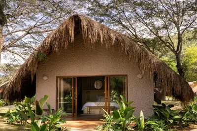 a small house with a thatched roof at Holistic EcoHotel in Santa Fe de Antioquia