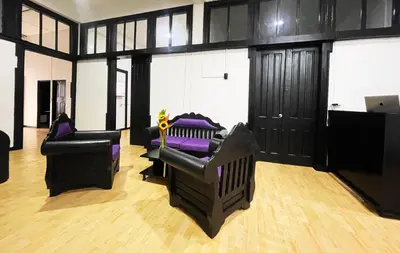 a living room with two chairs and a couch at Hotel Palacio in Manizales