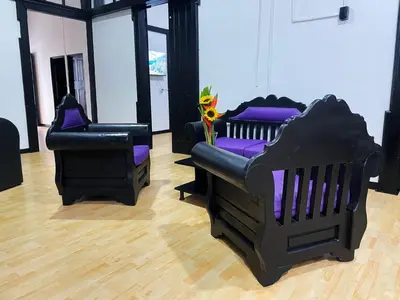 a room with two chairs and a baby crib at Hotel Palacio in Manizales