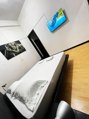 a bedroom with a bed and a tv on the wall at Hotel Palacio in Manizales