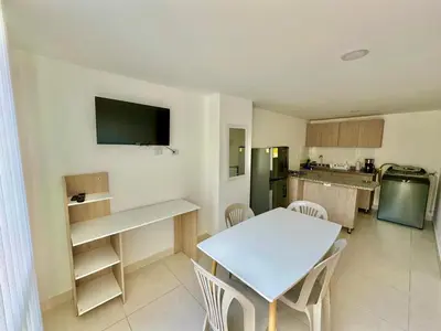 a kitchen with a white table and a table and chairs at Central Urbano 3 habitaciones hasta 8 personas CC Fundadores U Autonoma in Manizales