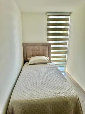 a bed in a white room with a window at Central Urbano 3 habitaciones hasta 8 personas CC Fundadores U Autonoma in Manizales