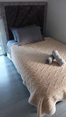 a bed with a stuffed animal laying on it at Central Urbano 3 habitaciones hasta 8 personas CC Fundadores U Autonoma in Manizales
