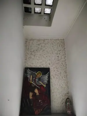 a painting of an angel on a wall in a room at Kumho in Medellín
