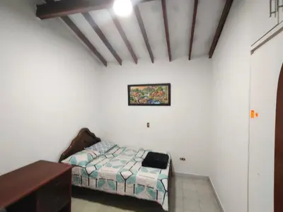 a bedroom with a bed and a desk in it at Kumho in Medellín