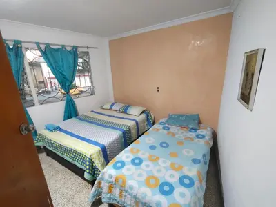 a bedroom with two beds and a window at Kumho in Medellín