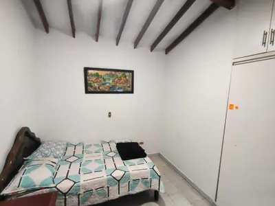 a bedroom with a bed and a painting on the wall at Kumho in Medellín