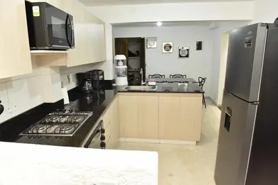 a kitchen with a stainless steel refrigerator and a sink at Laureles Sweet Home in Medellín