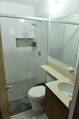 a bathroom with a shower and a toilet and a sink at Laureles Sweet Home in Medellín