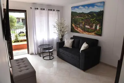 a living room with a couch and a table at Laureles Sweet Home in Medellín