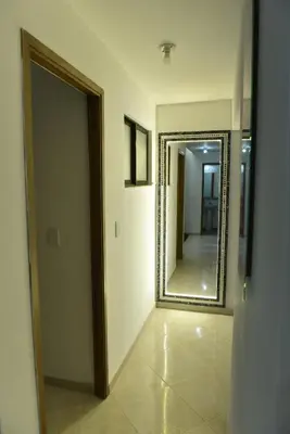 a hallway with a large mirror in a room at Laureles Sweet Home in Medellín