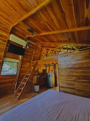 a bedroom with a bed and a wooden ceiling at Refugio la Arboleda in San Rafael