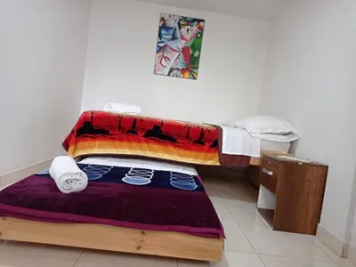 a small room with a bed and a table at La Recua Manizales in Manizales