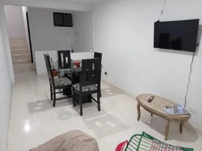 a living room with a table and chairs at La Recua Manizales in Manizales