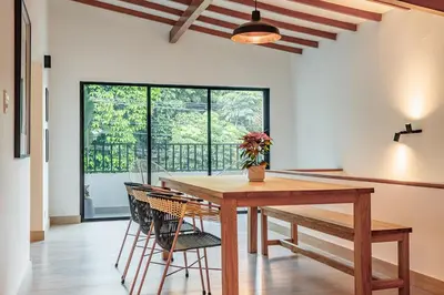 a dining room with a wooden table and chairs at NOK Peaceful 3BR in Medellin in Medellín