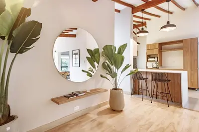 a living room with a mirror and a potted plant at NOK Peaceful 3BR in Medellin in Medellín