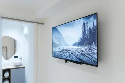 a flat screen tv hanging on a wall in a room at Fresco Living in Medellín