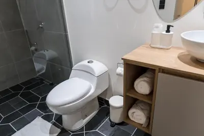 a bathroom with a toilet and a sink and a shower at Fresco Living in Medellín