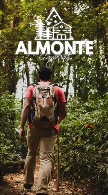 a man with a backpack walking down a trail at Almonte Glamping in Guarne