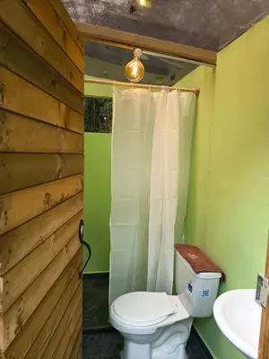 a bathroom with a toilet and a sink at Almonte Glamping in Guarne
