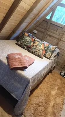 a bed with pillows on it in a room at Almonte Glamping in Guarne