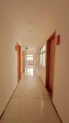 an empty hallway in a building with doors and a tile floor at Hotel MOVA in Medellín