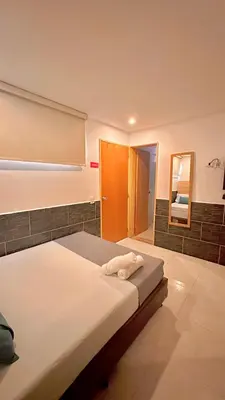 a bedroom with a bed and a mirror at Hotel MOVA in Medellín
