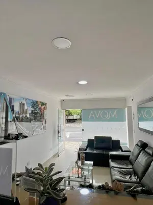 a living room with a couch and a table at Hotel MOVA in Medellín