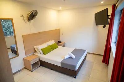 a bedroom with a bed and a television in it at Hotel MOVA in Medellín