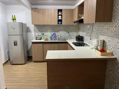a kitchen with a refrigerator and a counter top at La Casa de Oliva in Norcasia