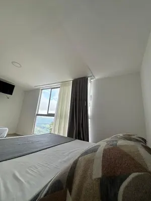 a bedroom with a large bed and a window at Hotel Boutique El Paisaje in Santa Bárbara