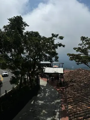 a view of a building with trees and a sidewalk at Hotel Boutique El Paisaje in Santa Bárbara