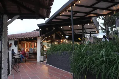 a restaurant with a patio with people sitting at tables at Hotel Boutique El Paisaje in Santa Bárbara