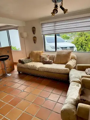 a living room with a couch and a window at Casa Finca en Guatapé in Guatapé