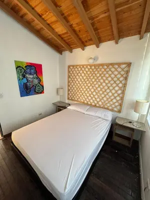 a bedroom with a large white bed and a window at Casa Finca en Guatapé in Guatapé