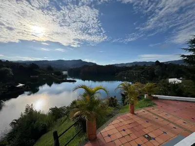 a view of a body of water with palm trees at Casa Finca en Guatapé in Guatapé