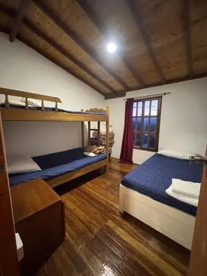 a bedroom with two bunk beds and a window at Cabaña descanso in Guarne