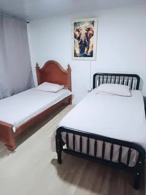 two beds sitting next to each other in a room at Balcones de la montaña in El Limón
