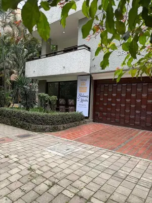 a building with a garage with a sign on it at Hotel Balcones De Malibu in Medellín