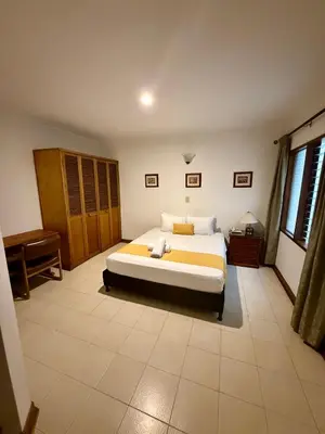a bedroom with a large bed in a room at Hotel Balcones De Malibu in Medellín