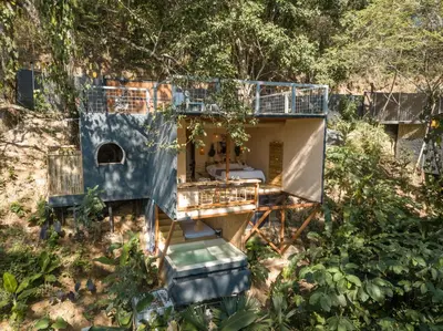 an aerial view of a house in the woods at Cabaña El Mamoncillo - Jacuzzi Privado con Calefacción y Malla Catamarán - Cerca a Medellín in Sopetran