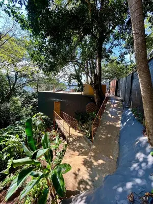 a house with a fence and trees and a sidewalk at Cabaña El Mamoncillo - Jacuzzi Privado con Calefacción y Malla Catamarán - Cerca a Medellín in Sopetran