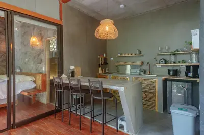 a kitchen with a table and chairs in a room at Cabaña El Bosque - En medio del bosque - Jacuzzi Privado con Calefacción y Malla Catamarán - Cerca a Medellin in Sopetran