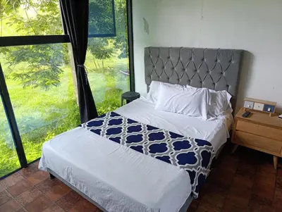 a bedroom with a bed and a large window at Siboney hotel in Honda