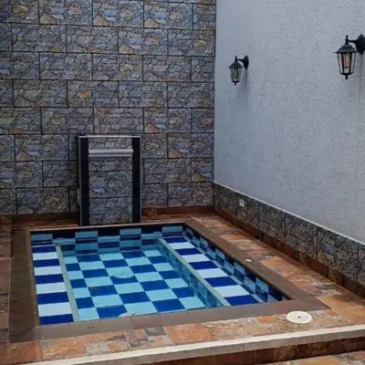 a swimming pool with a blue and white tile floor at Casa encanto, jacuzzi privado & wifi in Mariquita
