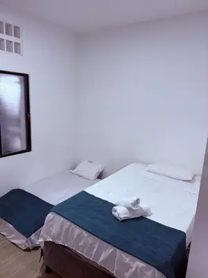 two beds in a room with towels on them at Casa encanto, jacuzzi privado & wifi in Mariquita