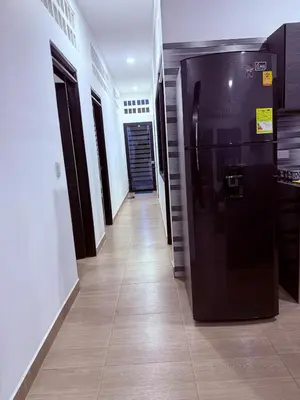 a hallway with a large black refrigerator in a building at Casa encanto, jacuzzi privado & wifi in Mariquita