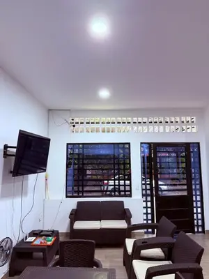 a living room with a couch and a tv at Casa encanto, jacuzzi privado & wifi in Mariquita